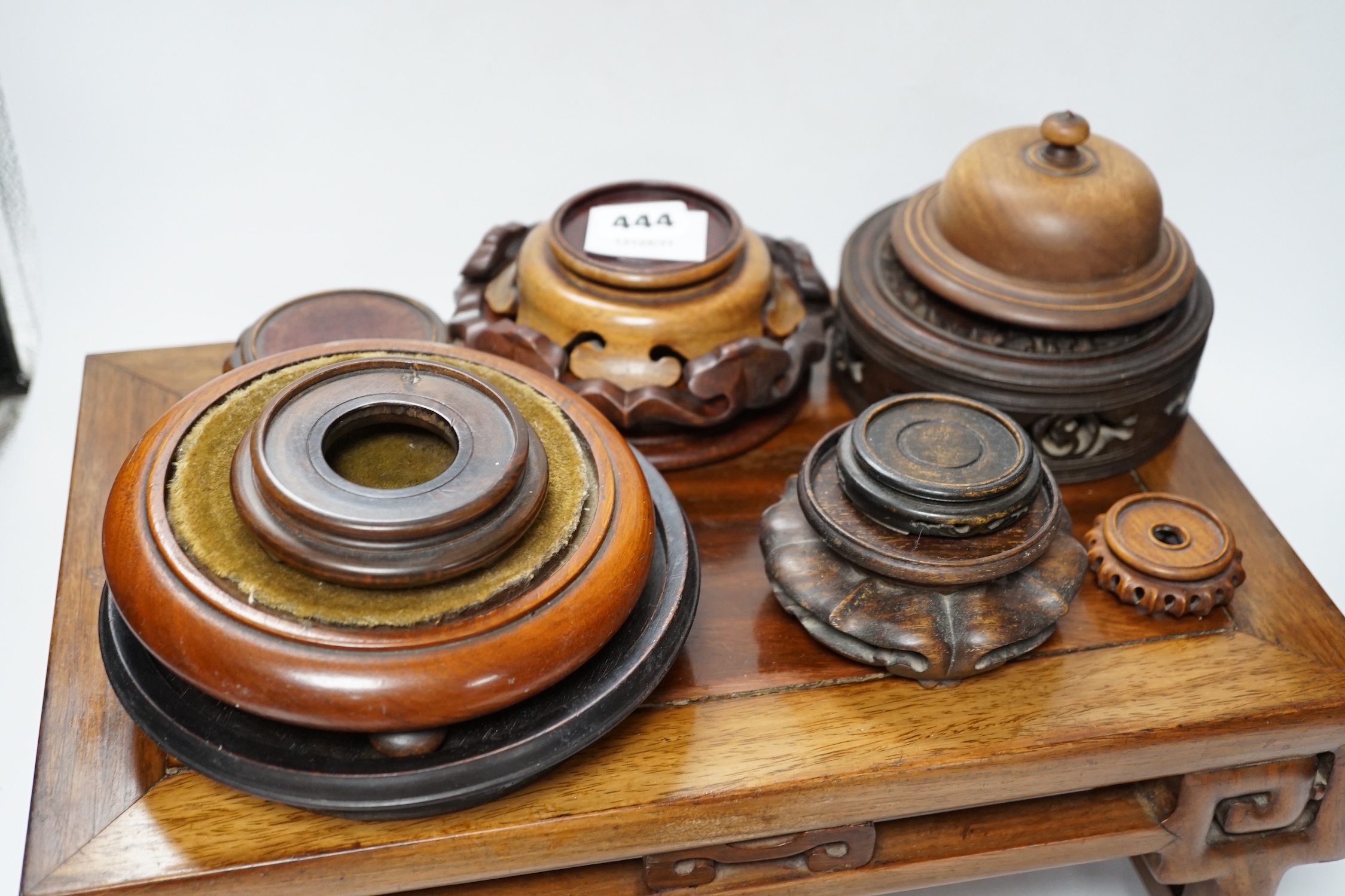 Nine Chinese hardwood vase stands, two hardwood covers and a Chinese hongmu table shaped stand, table 39cm x 25cm x 16.5cm